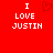Red background with white pixelated text 'I LOVE JUSTIN' on both sides and a red heart symbol between them.