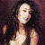 Static pixelated image of a person with long dark hair and light skin tone against a dark background, rendered in low-resolution style typical of early 2000s digital art.