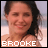 A 2x2 contact sheet of three animated frames showing a woman labeled BROOKE, a man labeled LUCAS, and them kissing with text BRUCAS.