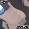 Pixelated image of a light-colored guitar body with visible fretboard and strings, featuring 'my' in top-left corner and 'Guitar' text at bottom-right.
