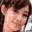 Pixelated image of a person with brown hair and a light-colored shirt on the left, and a pixelated anime-style character with black hair, red accents, and blue clothing on the right.