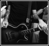 Black-and-white photo collage of three distinct band-related scenes: musicians playing electric guitars and a group portrait.