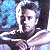 A pixelated contact sheet showing two frames of an animated icon featuring a person in a white outfit against a blue background on the left and green text reading "Original Icons .com" on the right.