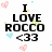 Pixelated text reads "I LOVE ROCCO <33" with pink and blue heart icons scattered around on a white background.