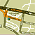Pixelated map with brown roads, orange paths, white lines, and small blue-green dots on a beige background.
