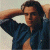 A pixelated image of a person in a blue shirt with arms raised behind their head, next to green text reading 'Original Icons .com' on a dark background.