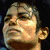 Pixelated image of a person's face with closed eyes, next to text reading "MJ R.I.P" and below it a yellow sad emoji on black background.