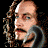 A 48x48 pixel animated buddy icon featuring a cartoon character with long hair and a beard on the left, transitioning to a golden