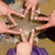 Pixelated static image of a figure with outstretched arms against a gradient background, featuring brown and purple elements.