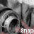 A grayscale animated icon shows a character's face with large eyes and a hand snapping, with the word 'snap' in pixelated text below.