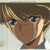 Pixelated close-up of a character with brown hair, blue eyes, and a neutral expression wearing a dark blue shirt.