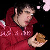A person in a red jacket holds a sandwich-like object while pink text overlays the image, with a dark background and pink circular shapes.