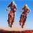 Animated sequence of two motorcyclists performing jumps over a dirt track against a clear blue sky, showing motion blur and sequential positions.