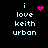 Pixelated text 'i love keith urban' with pink heart and starburst icons on black background, animated changes in icon positions.