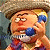 A pixelated cartoon character with a hat and blue nose holding a phone, next to green text reading "Original Icons .com" on a dark background.