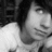 Black-and-white photo of a person with dark hair wearing a light shirt, shown in four with varying head angles and background elements