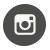 Pixelated white camera icon on dark gray circular background with rounded corners.