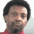 Pixelated image of a person with short dark hair wearing red clothing, alongside blue text reading "So What" and "Original Icons .com" on black backgrounds.