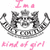 Pixelated icon with pink text above and below a grayscale castle-like structure on white background.