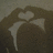 A static image of a brown-haired figure with white cat ears, forming a heart shape with hands above the head.