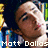 A pixelated image of a person with dark hair against a colorful bookshelf background, featuring partial text overlays.