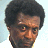 Pixelated image of a person with dark curly hair and light skin wearing a white shirt, alongside blue text reading "Man Of Mystery" and "OriginalIcons.com" on black backgrounds.