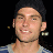 Pixelated image of a person with short dark hair wearing a blue and white striped shirt against black background, next to green text reading 'OriginalIcons.com' on solid green backdrop.