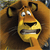 Pixelated close-up of a cartoon lion's face with wide eyes, open mouth showing teeth, and brown mane against a blurred background.
