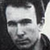 Pixelated grayscale portrait of a person with dark hair and neutral expression, displayed as static buddy icon on gray background.