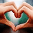 Two hands form a heart shape around a green and white object with text reading 'he stole my heart.'