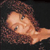 A pixelated close-up of a person with light skin and brown hair lying down, eyes closed, against a dark background.