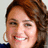 A pixelated image of a smiling person with brown hair and hoop earrings, split into four quadrants with text on two quadrants.
