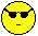 Two side-by-side pixelated yellow smiley faces with black sunglasses and straight-line mouths on a gray background, appearing as static frames from an animation.