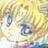 A pixelated close-up of a character's face with large blue eyes, light brown hair, and a soft yellow background.