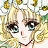 Pixelated close-up of a character with blonde hair, large dark eyes, and a neutral expression, surrounded by abstract yellow and green shapes.