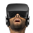 Pixelated image of a person wearing dark headphones with visible mouth open in mid-expression against gray background.