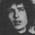 Pixelated grayscale image of a stylized human face with closed eyes, a small nose, and a faint smile, set against a dark background.