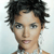 Pixelated close-up of a person with dark tousled hair, light skin, and neutral expression against light blue background.