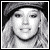 Black-and-white pixelated image of a person with long hair and a cap, accompanied by text reading "let the rain fall down and drown hillary's ass!!" on dark background.