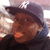 A person wearing a dark cap with white 'NY' logo and dark hoodie, shown in two where the head turns slightly left to right