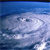 A static pixelated image of a blue sky with scattered white clouds, rendered in low resolution with visible pixelation.