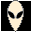 Pixelated alien head with large black eyes and a small mouth on black background, transitioning to a version with only two small black dots for eyes.