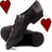 A pixelated black figure in a kneeling pose with two red hearts floating near its head against a white background.