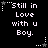Black background with white pixelated text reading "Still in Love with u Boy." surrounded by white and gray star-shaped icons with dotted lines.