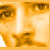 A pixelated image with repeated text and partial faces in warm brown tones, showing a static composition.