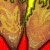 Pixelated image showing two brown hands with green accents on a red background, alongside text reading THE AMAZING JEWEL BROTHERS and a circular emblem with a white figure on yellow-orange gradient.