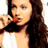 Static 48x48 pixel buddy icon showing a close-up of a person with long dark hair holding an orange object near their mouth against a white background.