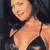 Pixelated static image of a person in a bikini top with dark hair against a dark background, rendered at low resolution.