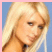Static pixelated image of a person with long blonde hair against a blue background, framed by pink border.