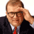 A contact sheet of seven animated frames from a Drew Carey show buddy icon featuring text, logos, and a partial photo of a man in business attire on a teal background.